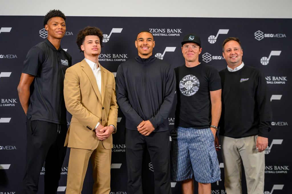 Utah Jazz draft picks and team officials at a press conference.
