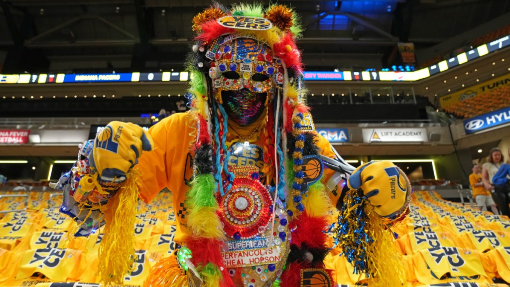 A Pacers superman surrounded by Yes 'Cers shirts