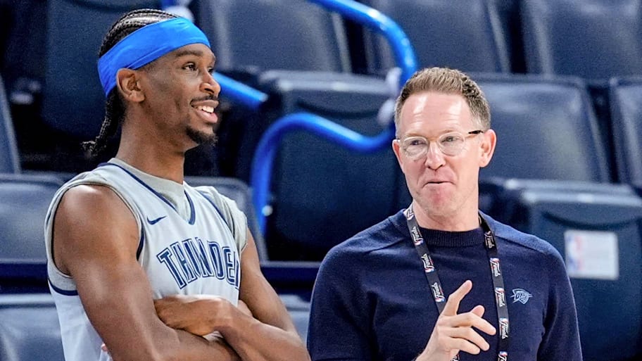 OKC general manager Sam Presti and guard Shai Gilgeous-Alexander talk prior to a game.