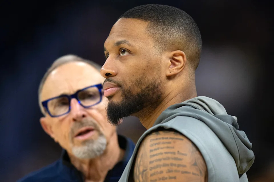 Milwaukee Bucks guard Damian Lillard (right) chats up Golden State Warriors assistant coach Ron Adams before a game.D&period; Ross Cameron-Imagn Images