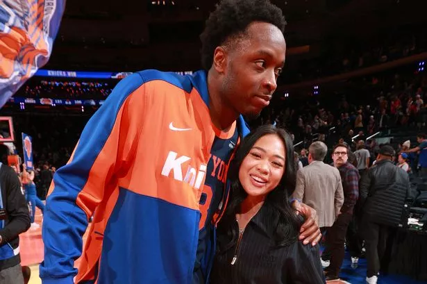 OG Anunoby #8 of the New York Knicks greets Suni Lee after the game against the Orlando Magic during the Emirates NBA Cup on December 3, 2024 at Madison Square Garden in New York City, New York