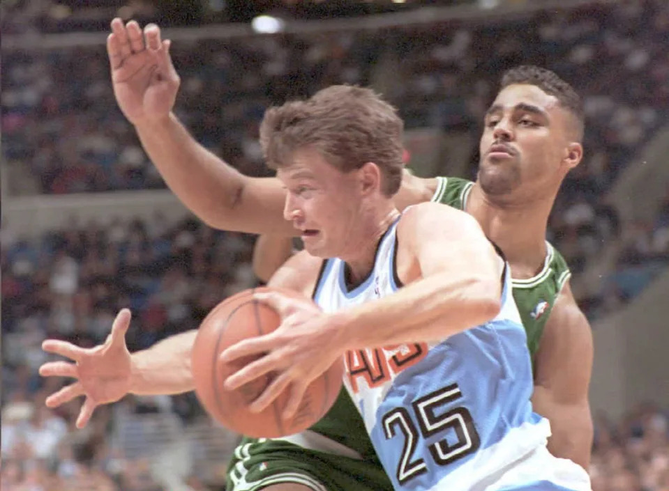 CLEVELAND, : Cleveland Cavaliers Mark Price (25) dribbles around the Boston Celtics Rick Fox 26 December. The action took place during the first half of their game at Gund Arena in Cleveland, Ohio. (COLOR KEY:Basketball is orange.) (Photo credit should read JEFF HAYNES/AFP via Getty Images)