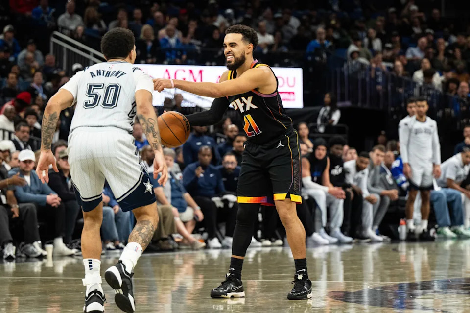 Phoenix Suns guard Tyus Jones dribbles the ball against Orlando Magic guard Cole Anthony.Jeremy Reper-Imagn Images