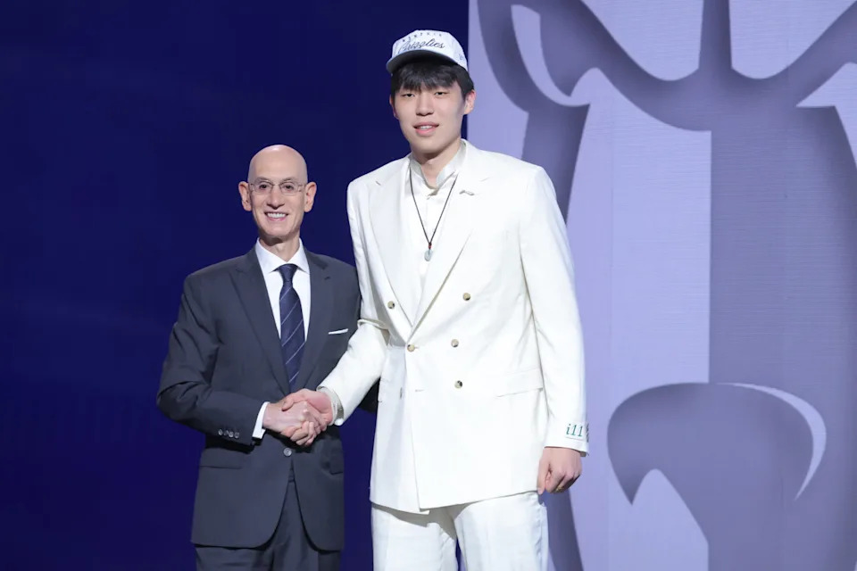 Yang Hansen stands with NBA commissioner Adam Silver Brad Penner-Imagn Images