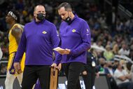 Los Angeles Lakers head coach Frank Vogel, right, and assistant coach Mike Penberthy talks...