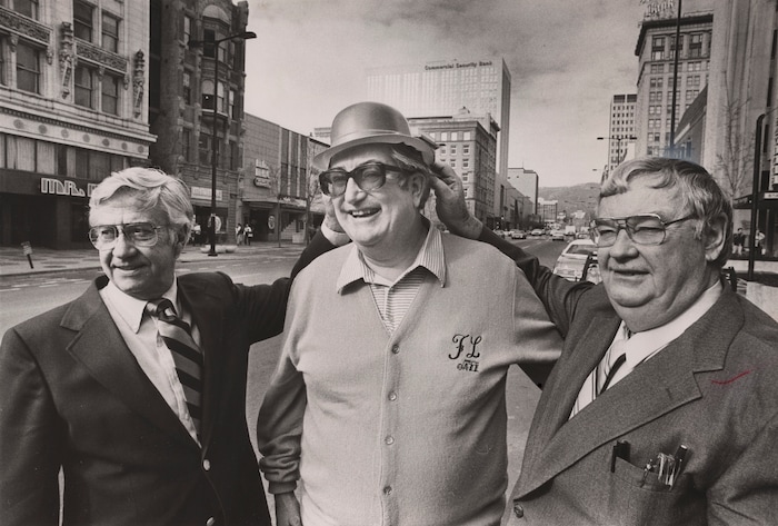 (The Salt Lake Tribune) Former St. Patrick's Day parade marshals Jack Green Jr., left, and John Mooney, right, pass on the derby hat to new marshal Frank Layden in 1981.