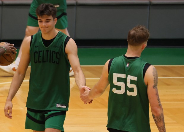 Hugo Gonzalez, left, and Baylor Scheierman slap hands during Celtics' summer league practice at the Auerbach Center. (Nancy Lane/Boston Herald)