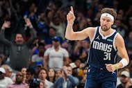 Dallas Mavericks guard Klay Thompson celebrates a basket during the second half of an NBA...