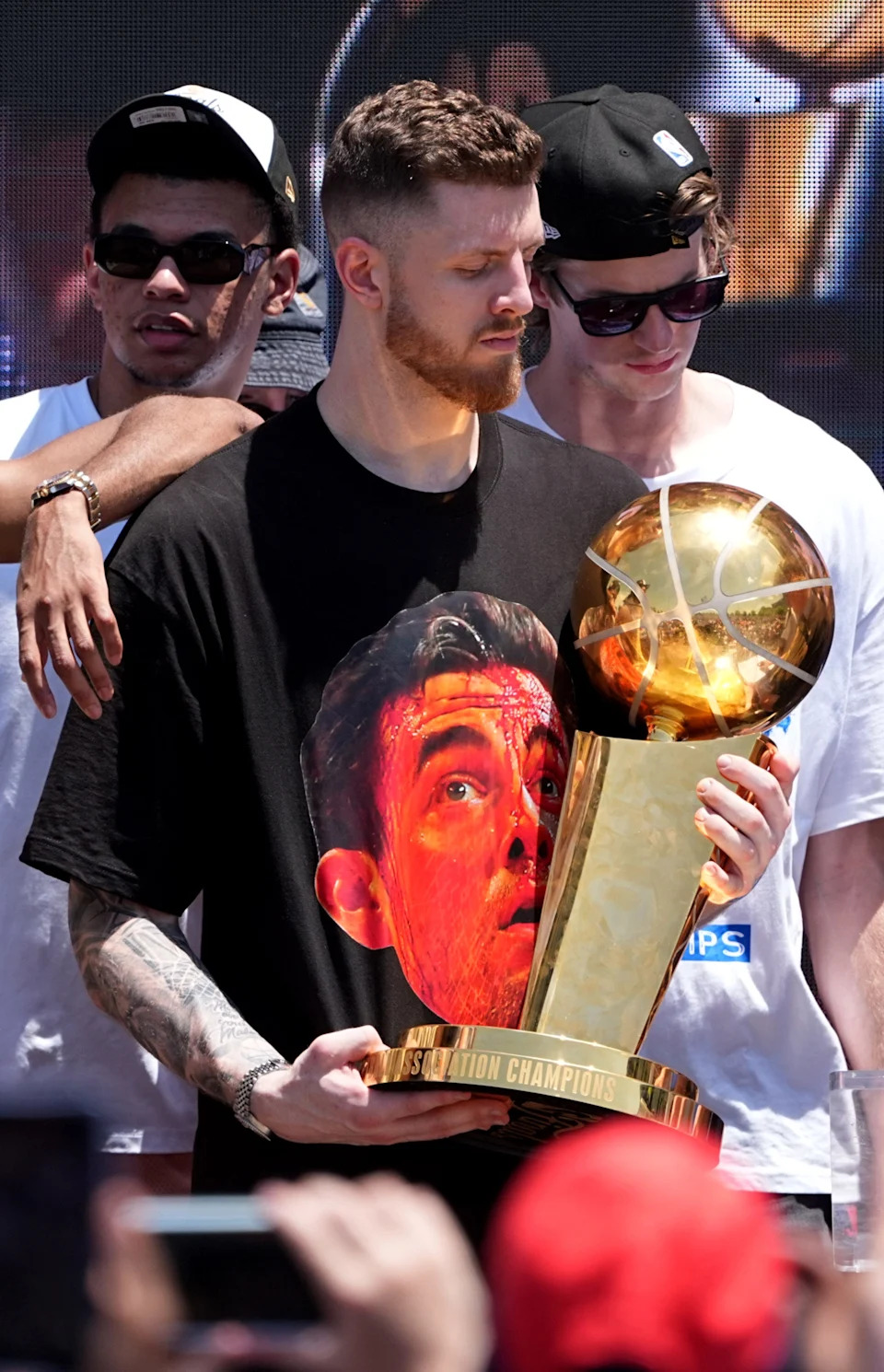 Oklahoma City's Isaiah Hartenstein holds the championship trophy at Scissortail Park as the Oklahoma City Thunder celebrate their first NBA Finals title win with a champions parade throughout downtown Oklahoma City on Tuesday, June 24, 2025.