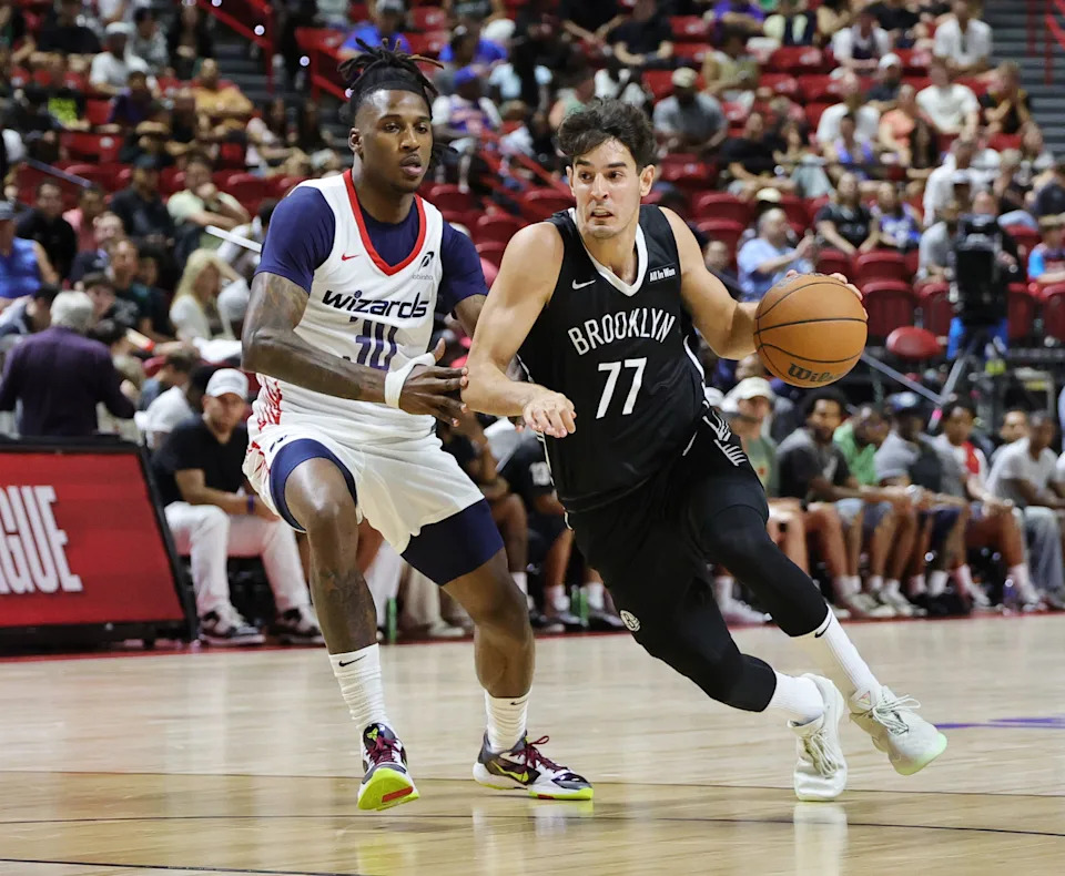 LAS VEGAS, NEVADA - JULY 13: Ben Saraf #77 of the Brooklyn Nets drives against Jamir Watkins #30 of the Washington Wizards in the first half of a 2025 NBA Summer League game at the Thomas & Mack Center on July 13, 2025 in Las Vegas, Nevada. NOTE TO USER: User expressly acknowledges and agrees that, by downloading and or using this photograph, User is consenting to the terms and conditions of the Getty Images License Agreement. (Photo by Ethan Miller/Getty Images)