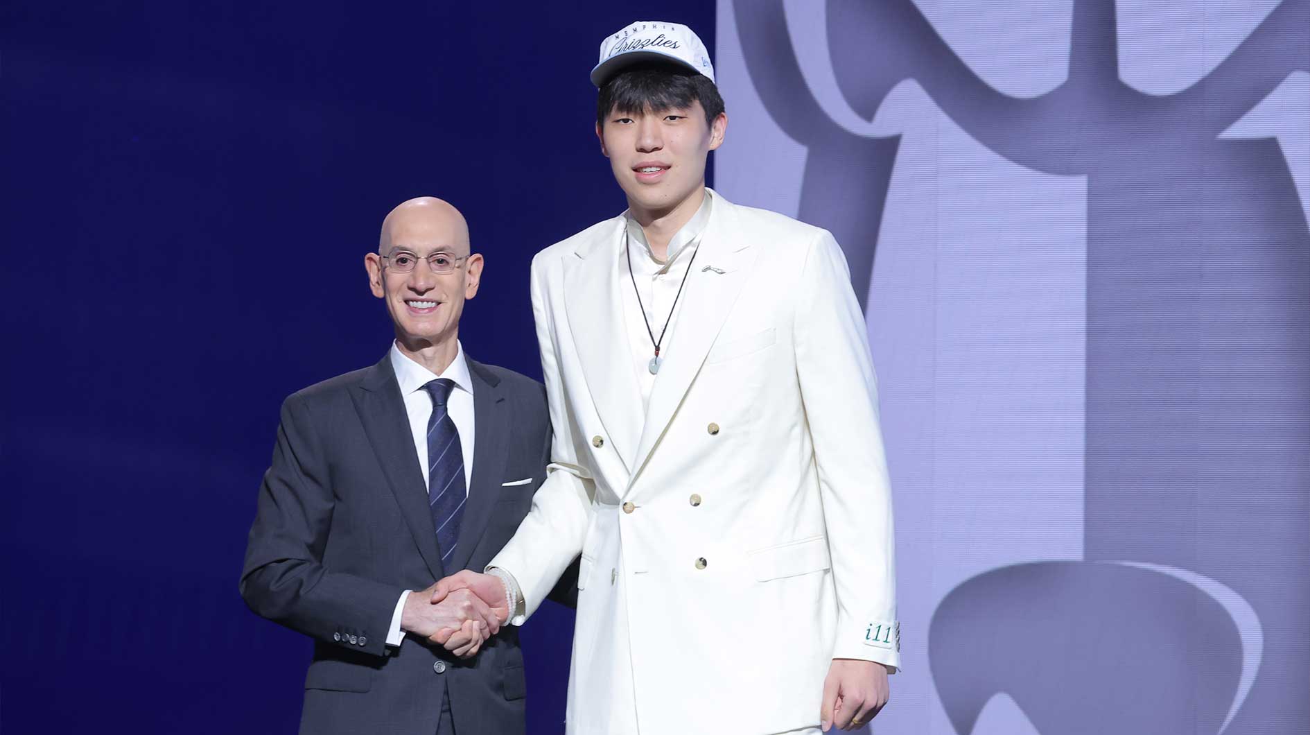Yang Hansen stands with NBA commissioner Adam Silver after being selected as the 16th pick by the Memphis Grizzlies in the first round of the 2025 NBA Draft at Barclays Center.