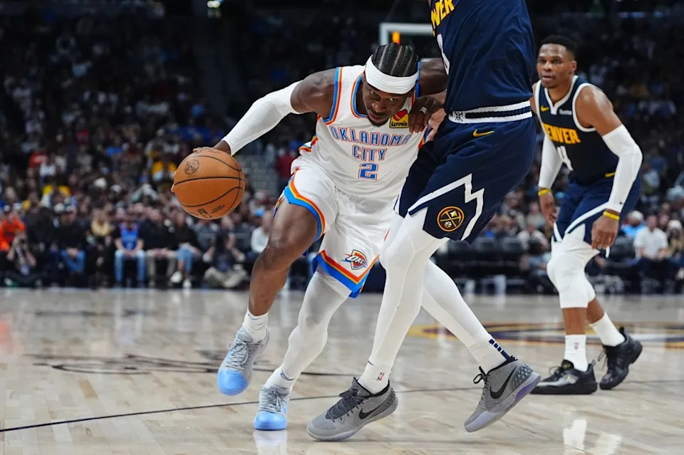 USA: Oklahoma City Thunder guard Shai Gilgeous-Alexander (2) drives at Denver Nuggets forward Peyton Watson (8) in the second quarter at Ball Arena.© Ron Chenoy-Imagn Images