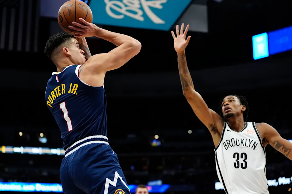 Nets center Nic Claxton (33) defends on Nuggets forward Michael Porter Jr.Ron Chenoy-Imagn Images
