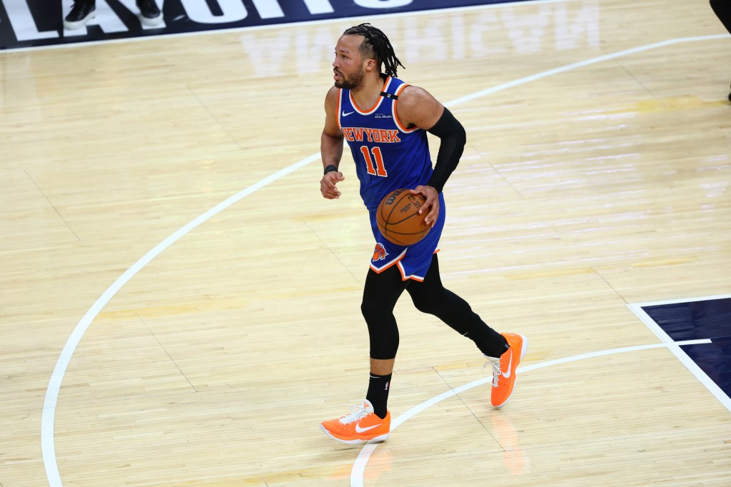 New York Knicks player dribbling the basketball.