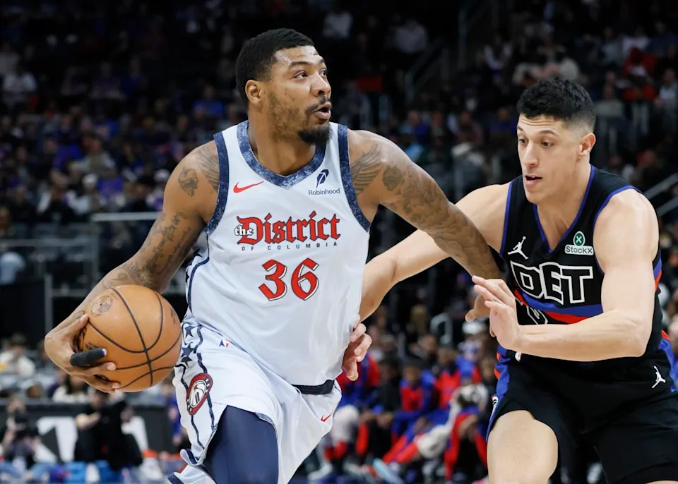 Wizards guard Marcus Smart, left, drives against Pistons forward Simone Fontecchio during a game last season.