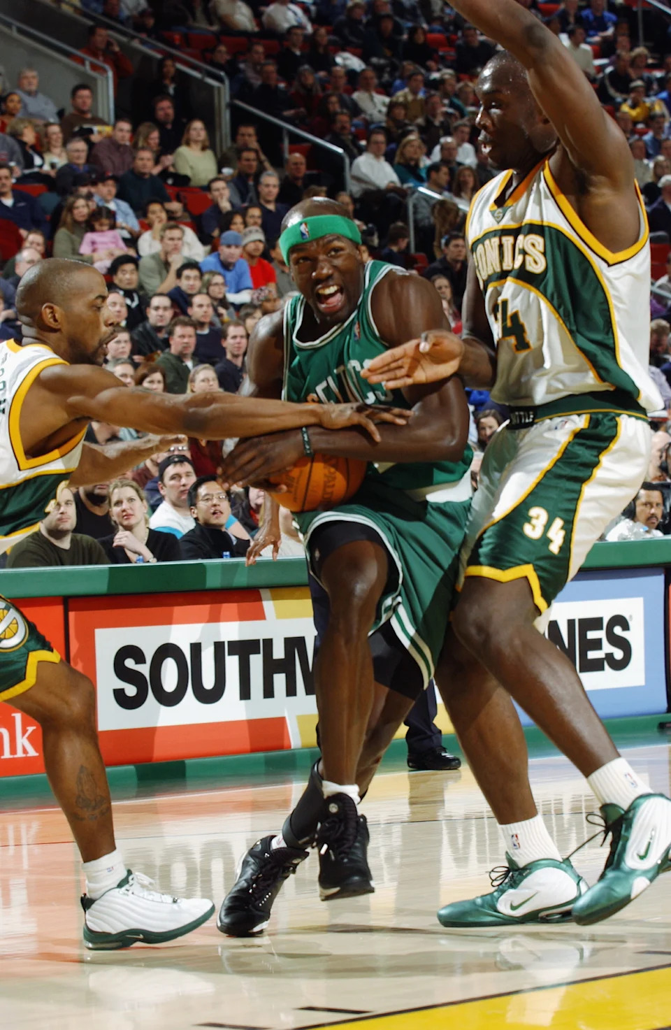 SEATTLE - FEBRUARY 11: Walter McCarty #0 of the Boston Celtics drives past Reggie Evans #34 of the Seattle Sonics during the game at Key Arena on February 11, 2003 in Seattle, Washington. The Celtics won 82-76. NOTE TO USER: User expressly acknowledges and agrees that, by downloading and/or using this photograph, User is consenting to the terms and conditions of the Getty Images License Agreement. (Photo By Otto Greule/Getty Images)