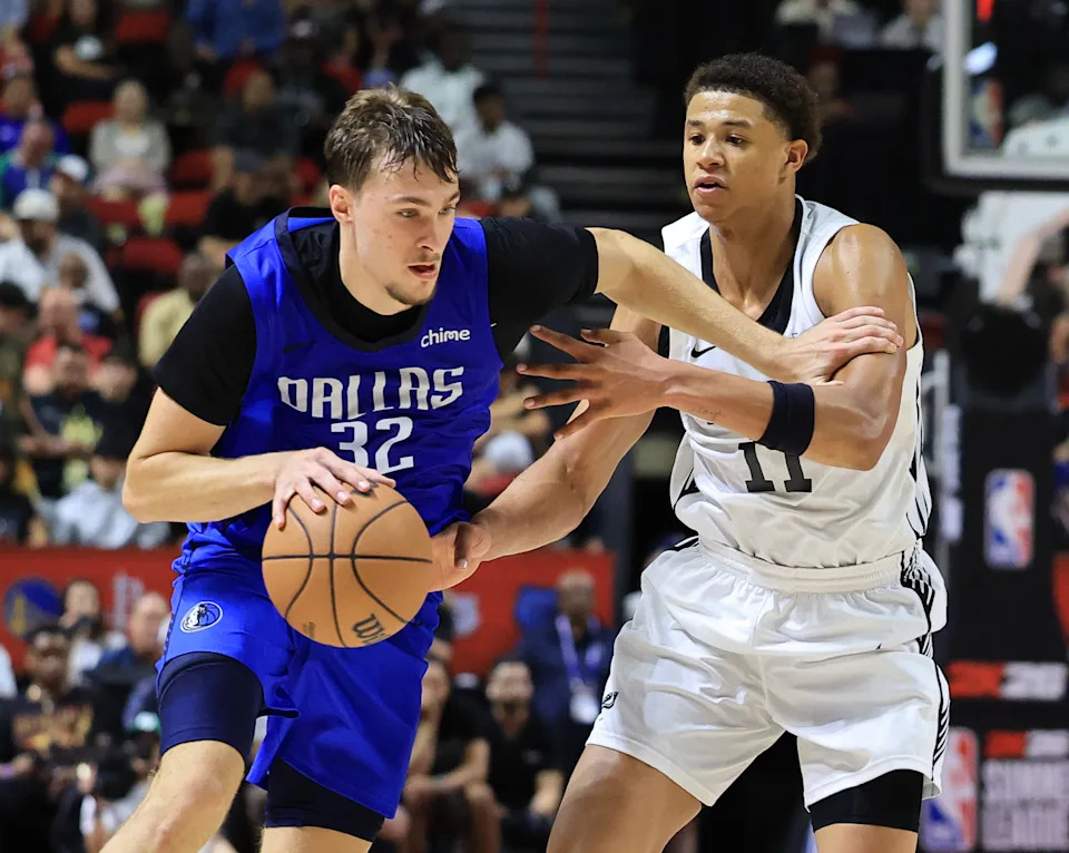LAS VEGAS, NEVADA - JULY 12: Cooper Flagg #32 of the Dallas Mavericks is fouled by Carter Bryant #11 of the San Antonio Spurs in the second half of a 2025 NBA Summer League game at the Thomas & Mack Center on July 12, 2025 in Las Vegas, Nevada. NOTE TO USER: User expressly acknowledges and agrees that, by downloading and or using this photograph, User is consenting to the terms and conditions of the Getty Images License Agreement. (Photo by Ethan Miller/Getty Images)