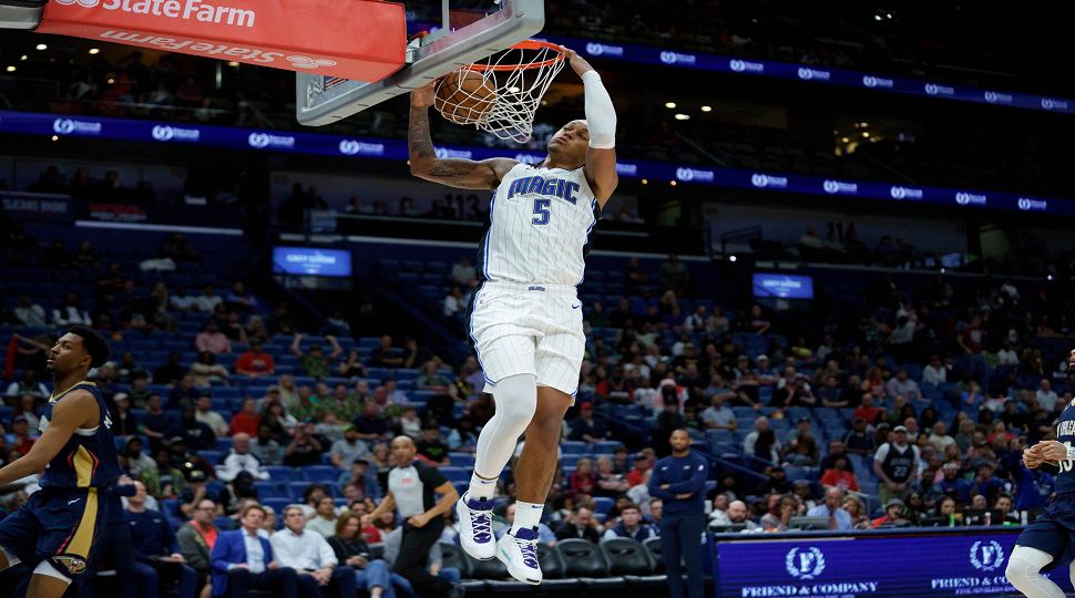 Orlando Magic forward Paolo Banchero (5) breaks free for a dunk against New Orleans Pelicans guard Trey Murphy III (25) during the second half of an NBA basketball game in New Orleans, Thursday, March 13, 2025. (AP Photo/Matthew Hinton)