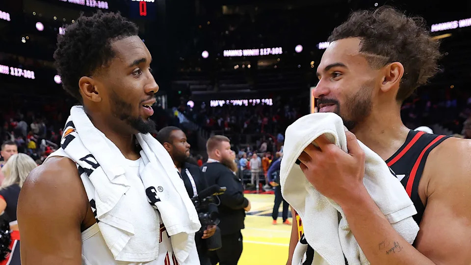 ATLANTA, GEORGIA - NOVEMBER 29:  Trae Young #11 of the Atlanta Hawks reacts with Donovan Mitchell #45 of the Cleveland Cavaliers after their 117-101 win during the Emirates NBA Cup game at State Farm Arena on November 29, 2024 in Atlanta, Georgia.  NOTE TO USER: User expressly acknowledges and agrees that, by downloading and/or using this photograph, user is consenting to the terms and conditions of the Getty Images License Agreement.  (Photo by Kevin C. Cox/Getty Images)