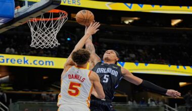 Orlando Magic forward Paolo Banchero, right, tries to shoot over Atlanta Hawks guard Dyson Daniels, left, during the second half of an NBA basketball game, Tuesday, April 8, 2025, in Orlando, Fla. (AP Photo/John Raoux)