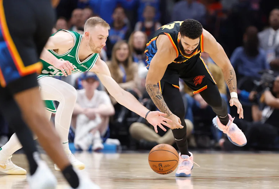 Jan 5, 2025; Oklahoma City, Oklahoma, USA; Boston Celtics forward Sam Hauser (30) and Oklahoma City Thunder forward Kenrich Williams (34) reach for a loose ball during the second quarter at Paycom Center. Mandatory Credit: Alonzo Adams-Imagn Images