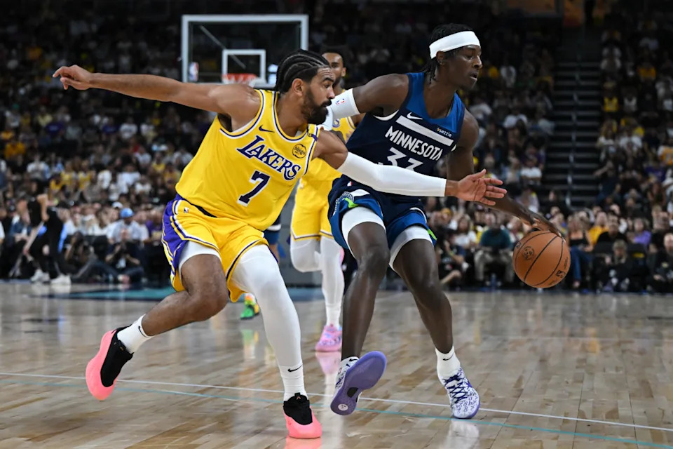Los Angeles Lakers guard Gabe Vincent (7) passes against Minnesota Timberwolves forward Leonard Miller (33)