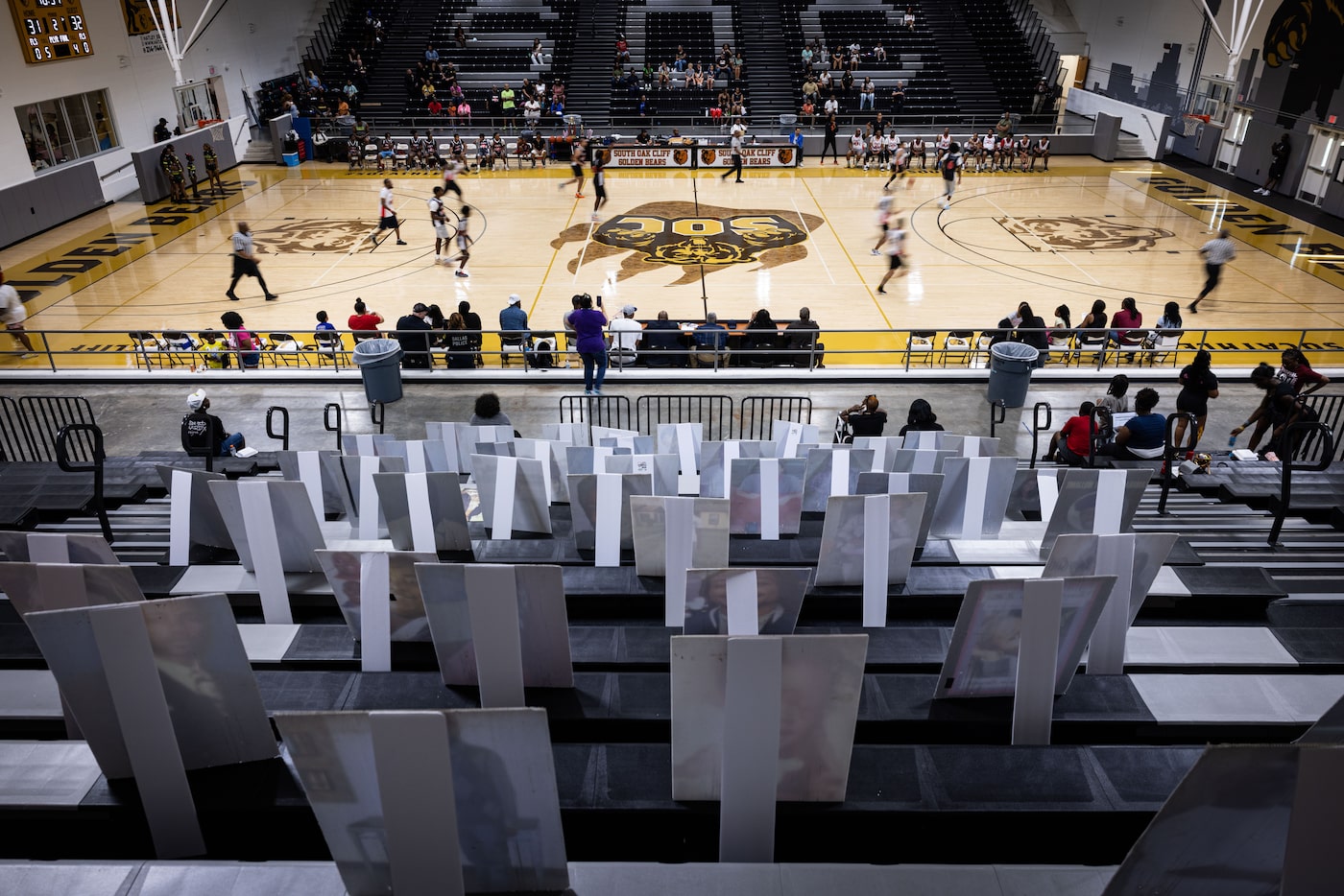 Photos of deceased loved ones printed on posters are displayed in the bleachers during No...