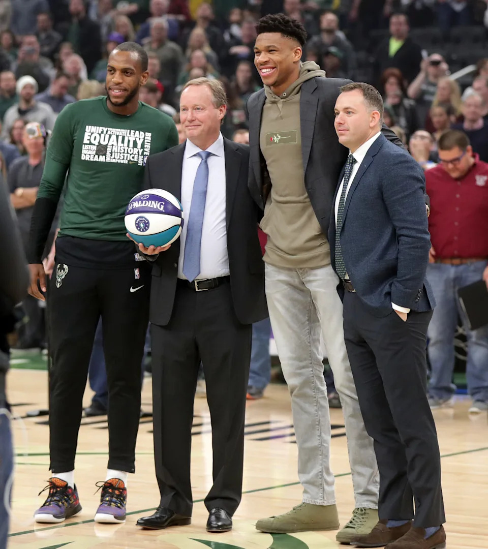 Giannis Antetokounmpo and Khris Middleton pose for a photo with head coach Mike Budenholzer and general manager Jon Horst during the 2018-19 season to celebrate being named to the All-Star team. Former Bucks forward John Henson said Antetokounmpo once shut down a trade request involving Middleton for Jimmy Butler.
