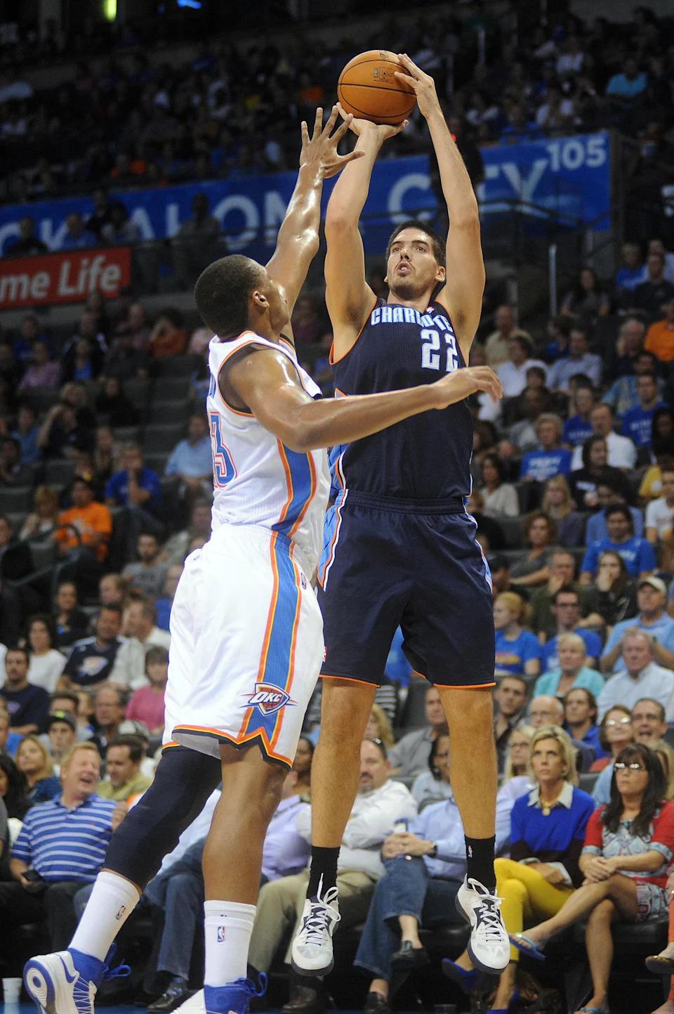 Oct 16, 2012; Oklahoma City, OK, USA; Charlotte Bobcats forward Byron Mullins (22) takes a shot while being guarded by Oklahoma City Thunder center Daniel Orton (33) during the first half at Chesapeake Energy Arena. Mandatory Credit: Mark D. Smith-USA TODAY Sports