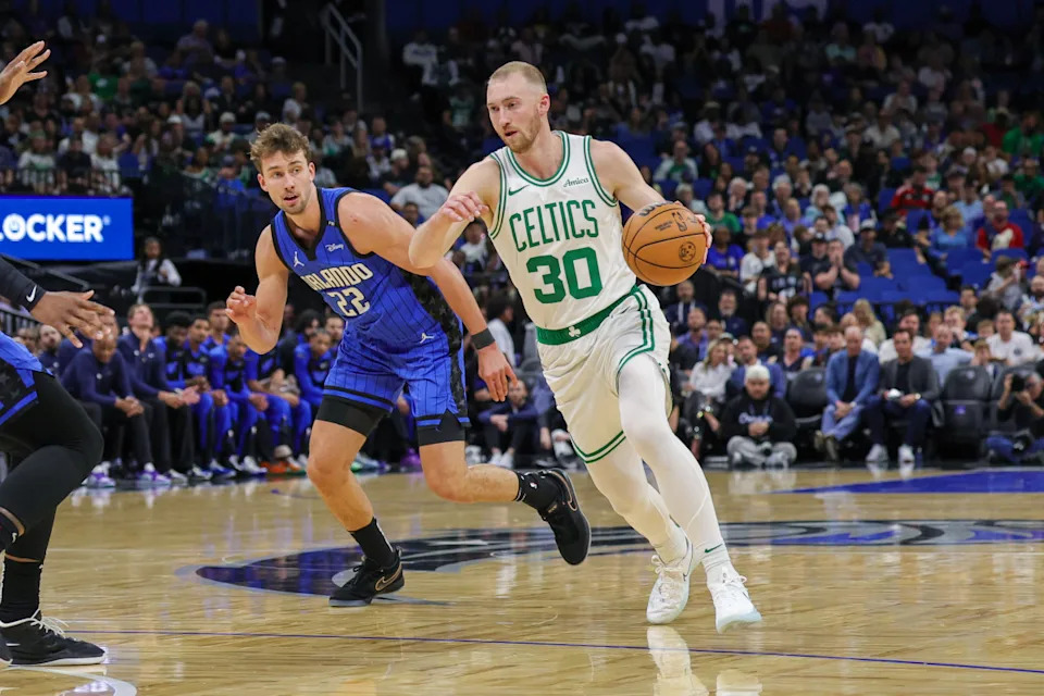 Apr 9, 2025; Orlando, Florida, USA; Boston Celtics forward Sam Hauser (30) brings the ball up court in front of Orlando Magic forward Franz Wagner (22) during the first quarter at Kia Center. Mandatory Credit: Mike Watters-Imagn Images Mandatory Credit: Mike Watters-Imagn Images
