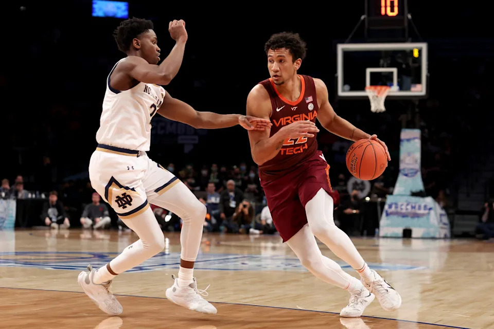 Mar 10, 2022; Brooklyn, NY, USA; Virginia Tech Hokies forward Keve Aluma (22) drives to the basket against Notre Dame Fighting Irish guard Trey Wertz (2) during the second half at Barclays Center. Mandatory Credit: Brad Penner-USA TODAY Sports