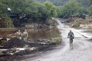Law enforcement officers work along the Guadalupe River,  Saturday, July 5, 2025, in Hunt. A...