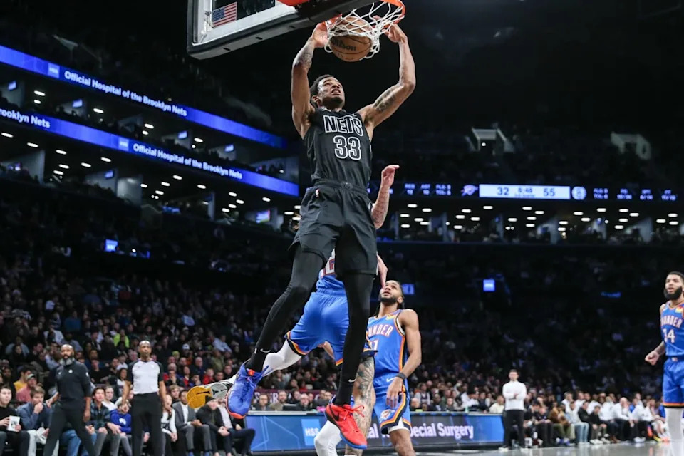 Jan 5, 2024; Brooklyn, New York, USA; Brooklyn Nets center Nic Claxton (33) dunks past Oklahoma City Thunder forward Lindy Waters III (12) in the second quarter at Barclays Center. Mandatory Credit: Wendell Cruz-Imagn Images Credit: Wendell Cruz-Imagn Images
