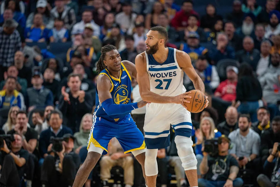 Golden State Warriors forward Kevon Looney (5) guards guards Minnesota Timberwolves center Rudy Gobert (27).© Neville E&period; Guard-Imagn Images