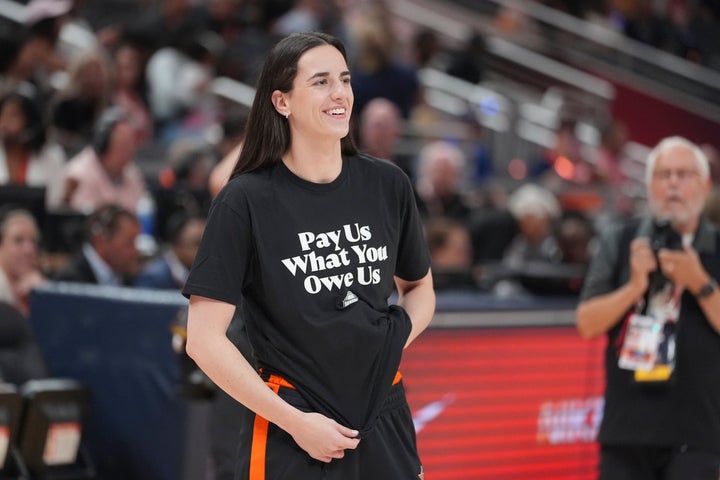 Indiana Fever's Caitlin Clark watches before the WNBA All-Star basketball game, Saturday, July 19, 2025, in Indianapolis. (AP Photo/Michael Conroy)