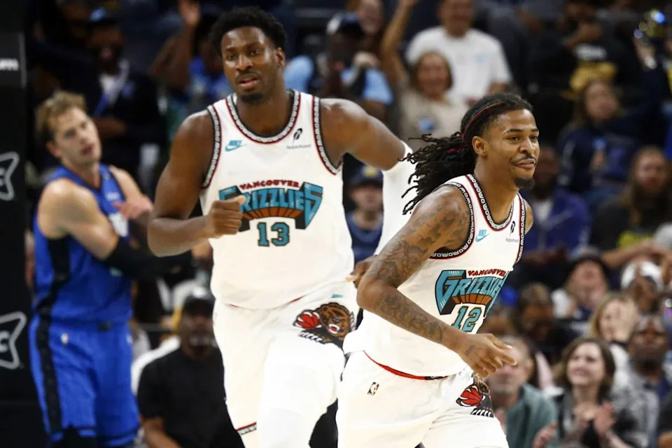 Memphis Grizzlies forward Jaren Jackson Jr. (13) and guard Ja Morant (12) get back on defense during the first half against the Orlando Magic at FedExForum.Mandatory Credit: Petre Thomas-Imagn Images