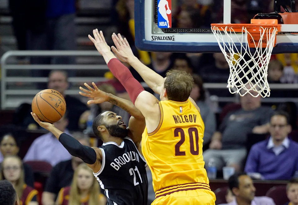 Mar 31, 2016; Cleveland, OH, USA; Brooklyn Nets guard Wayne Ellington (21) shoots against Cleveland Cavaliers center Timofey Mozgov (20) in the third quarter at Quicken Loans Arena. Mandatory Credit: David Richard-USA TODAY Sports
