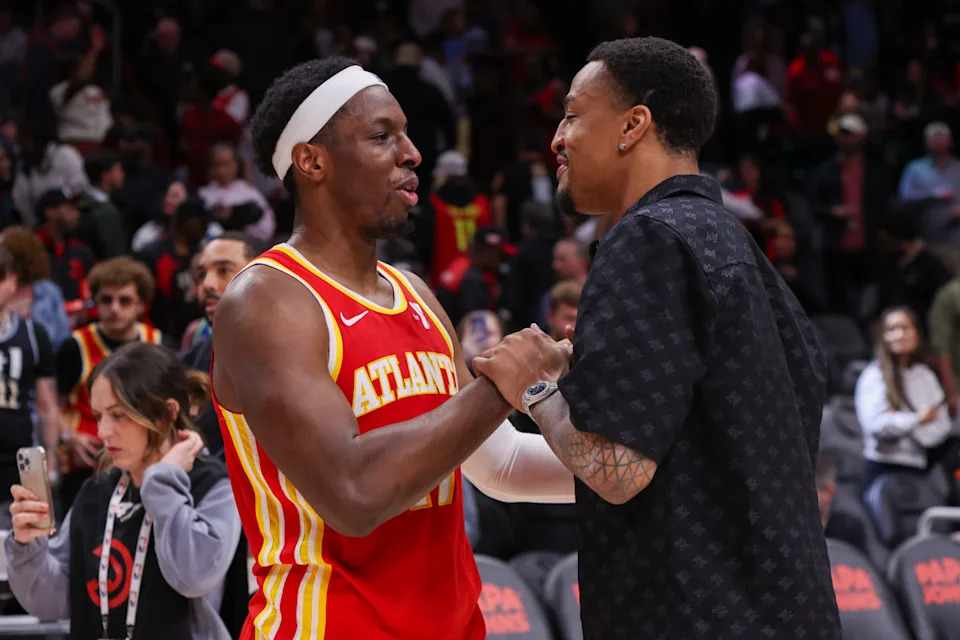 Atlanta Hawks center Onyeka Okongwu (left) talks to former teammate John Collins (right) after a game at State Farm Arena.Brett Davis-Imagn Images