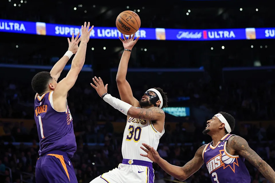 Jordan Goodwin #30 of the Los Angeles Lakers drives to the basket defended by Devin Booker #1 of the Phoenix Suns in the first half at Crypto.com Arena on March 16, 2025, in Los Angeles.