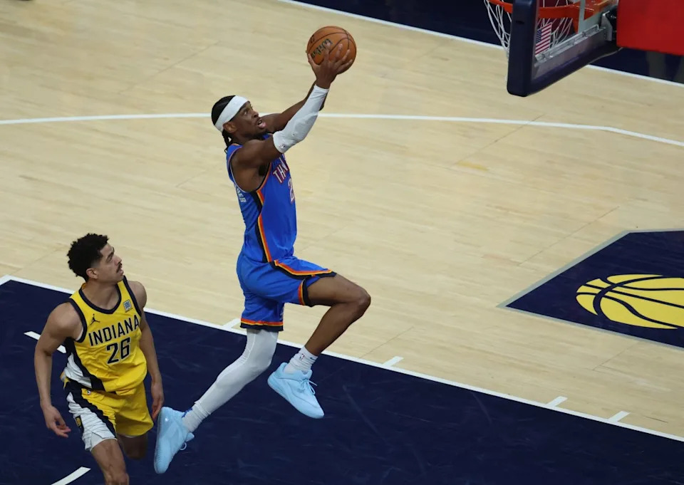 Oklahoma City Thunder guard Shai Gilgeous-Alexander rises to dunk the ball as Indiana Pacers guard Ben Sheppard looks on during Game 4 of the NBA Finals at Gainbridge Fieldhouse on June 13, 2025.Trevor Ruszkowski-Imagn Images