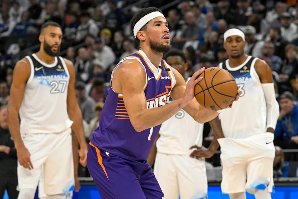 Nov 17, 2024; Minneapolis, Minnesota, USA; Phoenix Suns guard Devin Booker (1) shoots a free-throw against the Minnesota Timberwolves during the first quarter at Target Center.Nick Wosika-Imagn Images