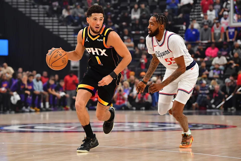 Phoenix Suns guard Devin Booker pushes the ball upcourt as Los Angeles Clippers forward Derrick Jones Jr. defends at Intuit Dome on Oct. 31, 2024.Gary A. Vasquez-Imagn Images