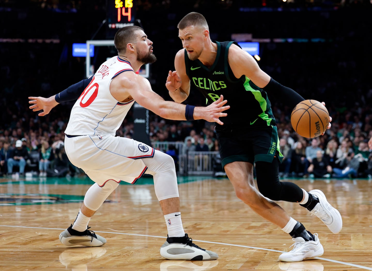 Celtics center Kristaps Porzingis (8) got a good test in his first game of the season, battling physical Clippers center Ivica Zubac all night. 