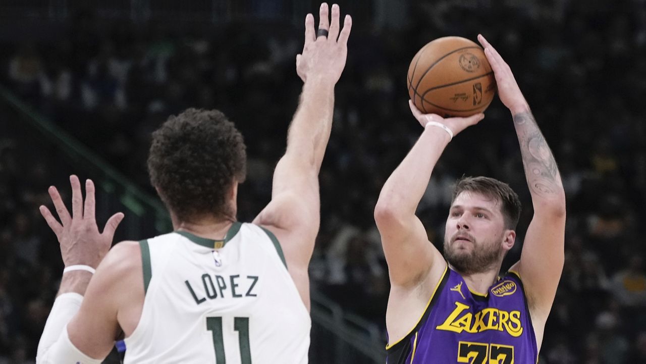 Los Angeles Lakers' Luka Doncic shoots past Milwaukee Bucks' Brook Lopez during the first half of an NBA basketball game Thursday, Mar. 13, 2025, in Milwaukee. (AP Photo/Morry Gash)