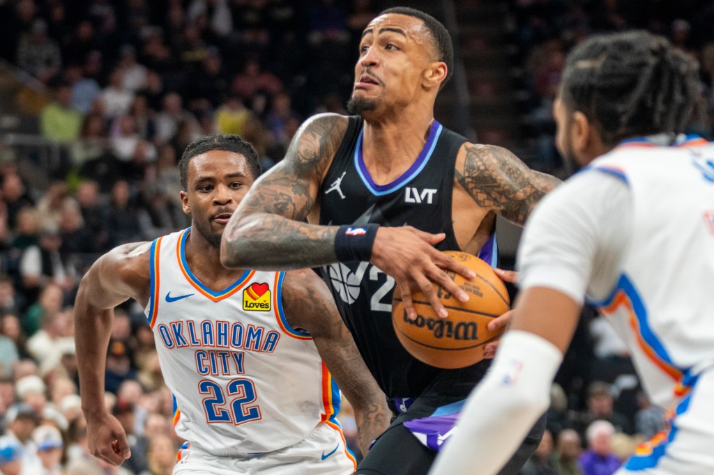 Luguentz Dort and Lauri Markkanen playing basketball.