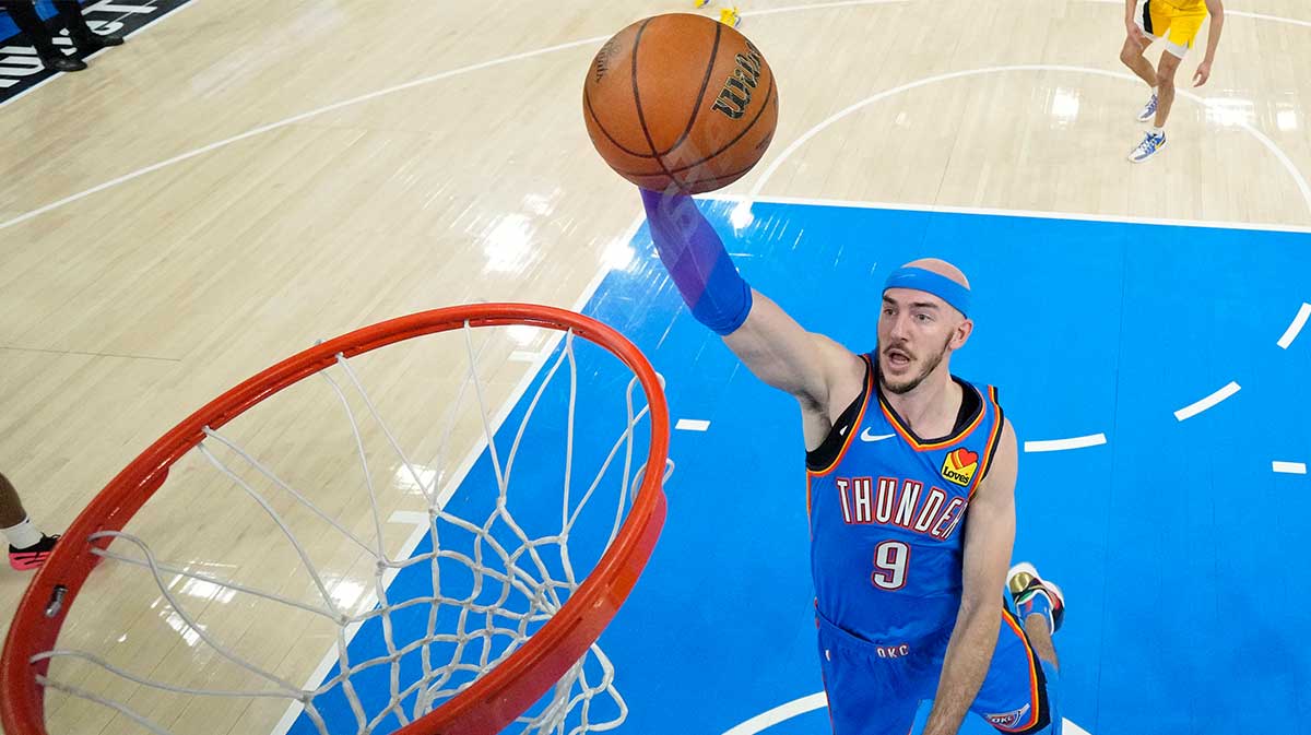 Oklahoma City Thunder guard Alex Caruso (9) dunks against the Indiana Pacers during the first half of game seven of the 2025 NBA Finals at Paycom Center. 