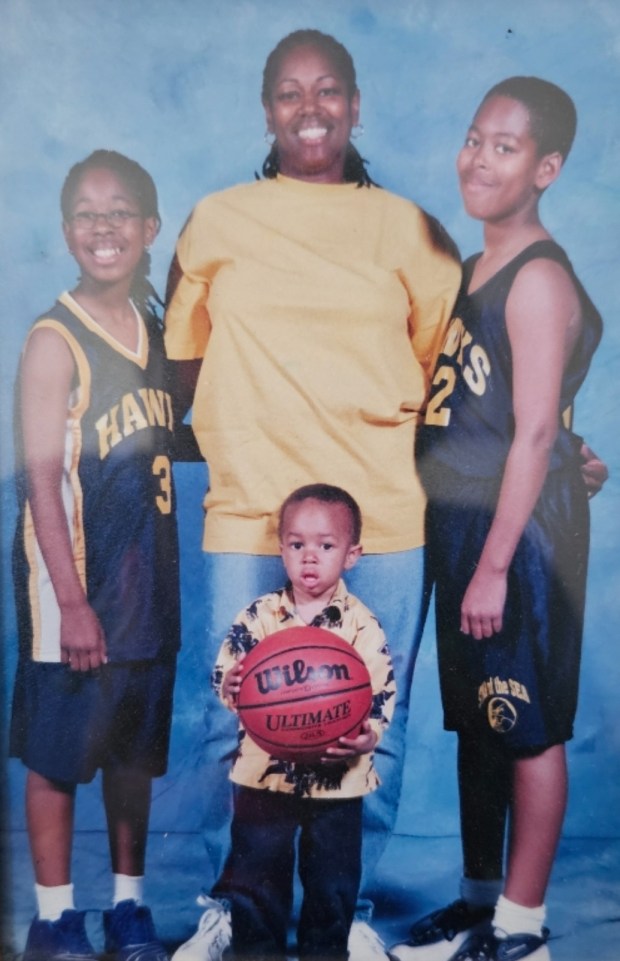 Photo of Chance McMillian (middle) with sister Joi (left), brother Justin (right) and mother Judy (center) (Photo courtesy of Judy Bowers)