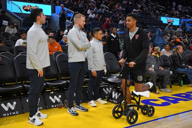 Golden State Warriors' Chance McMilliam (25) rolls past head coach Lainn Wilson before their game against the San Antonio Spurs during the California Classic Summer League game at Chase Center in San Francisco, Calif., on Sunday, July 6, 2025. (Jose Carlos Fajardo/Bay Area News Group)