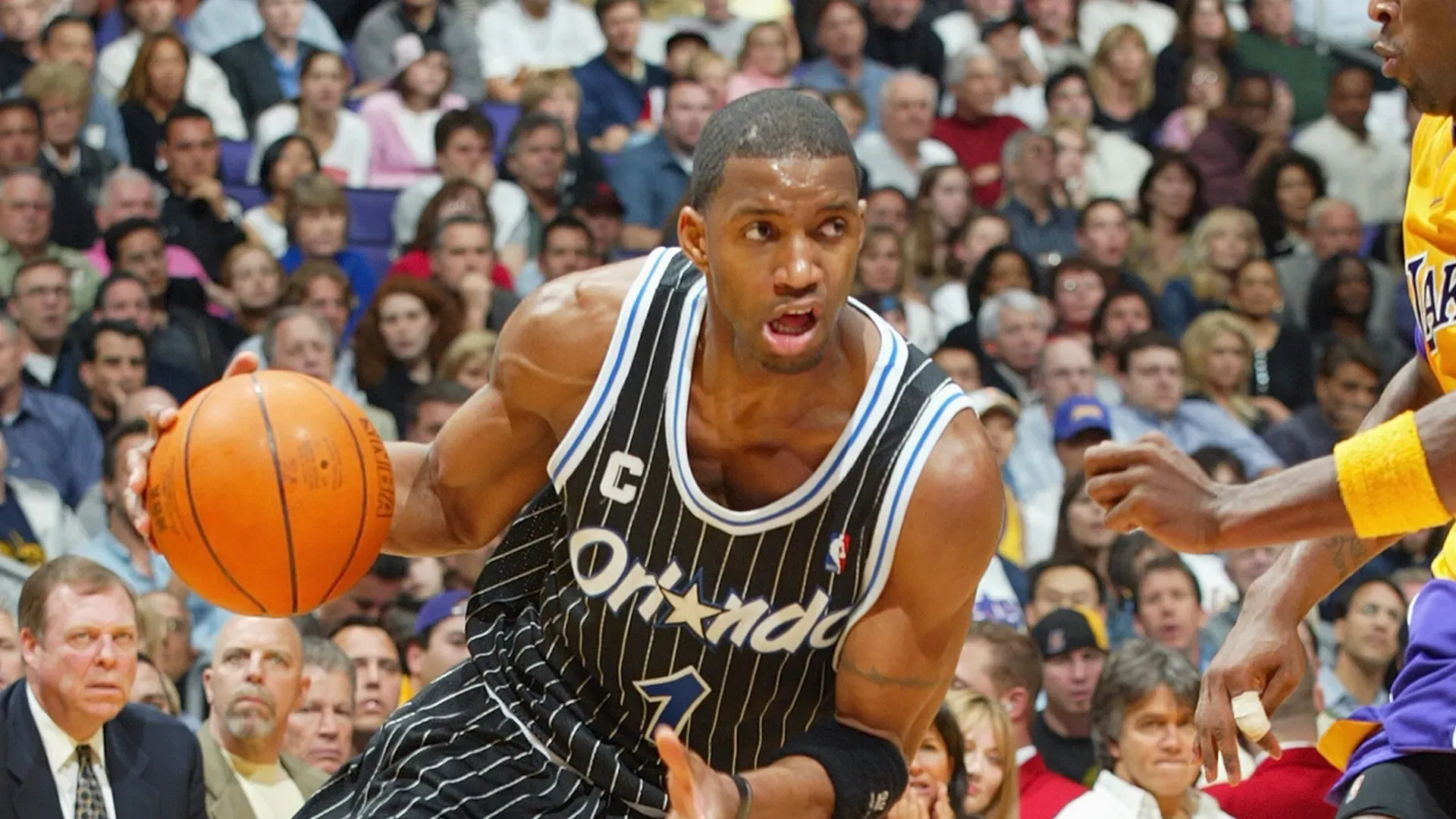 Tracy McGrady #1 of the Orlando Magic drives past Kobe Bryant #8 of the Los Angeles Lakers during the game at Staples Center