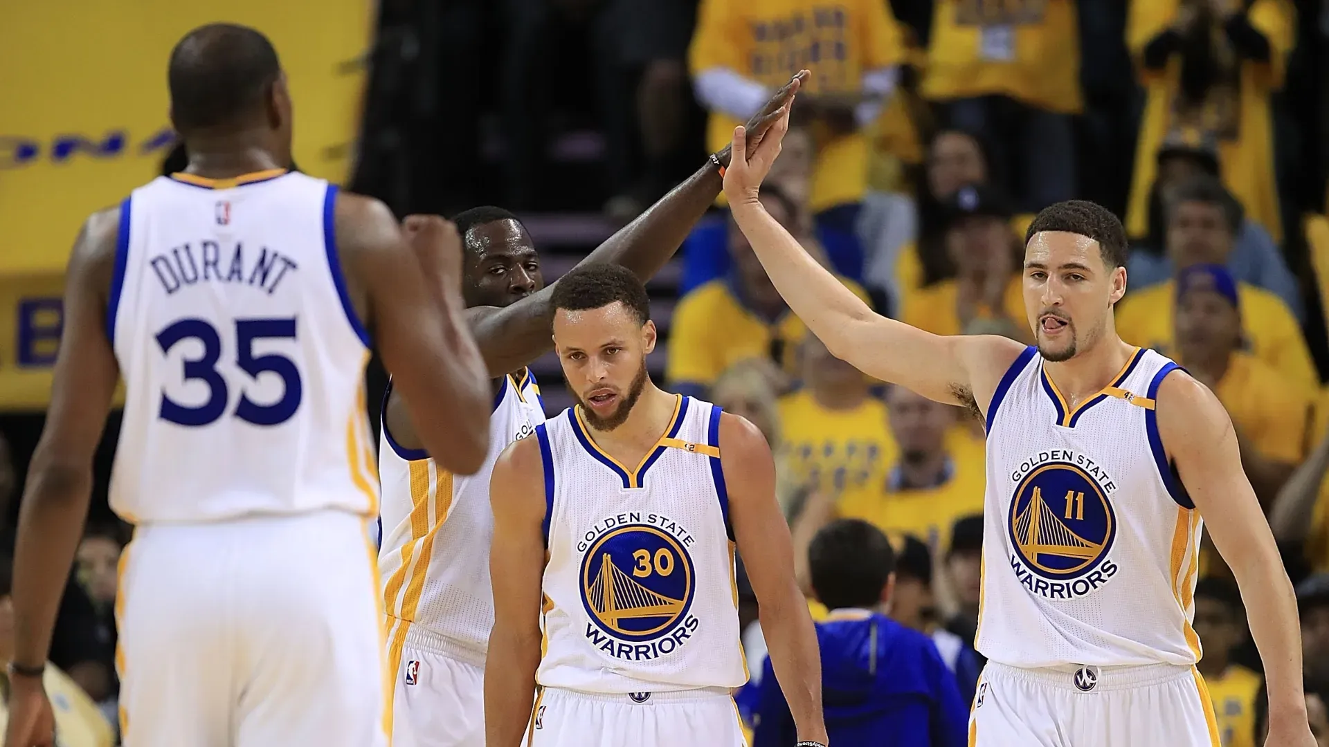 Kevin Durant #35, Draymond Green #23 and Klay Thompson #11 of the Golden State Warriors react with Stephen Curry #30 against the Utah Jazz during Game Two of the NBA Western Conference Semi-Finals at ORACLE Arena on May 4, 2017 in Oakland, California.
